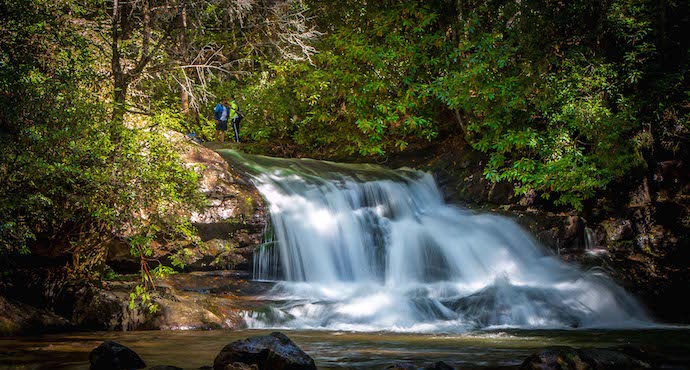 Couple standing atop Hemlock Falls, GA