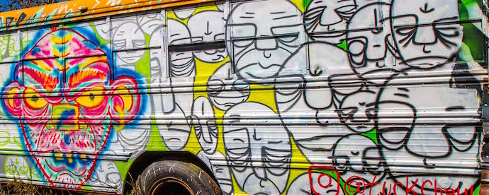 Faces Mural on Painted School Bus at Schoolbus Graveyard, North GA