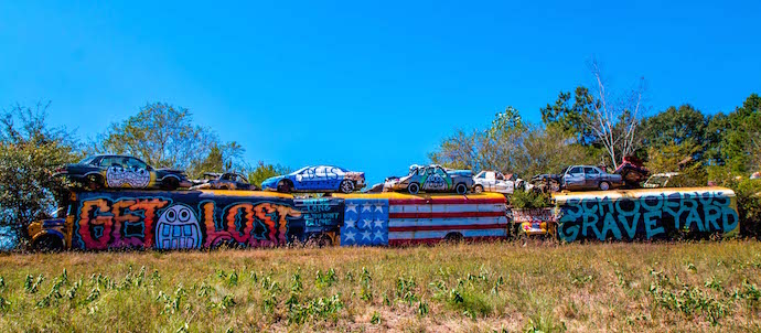 Line of Painted School Buses at Schoolbus Graveyard in North Georgia