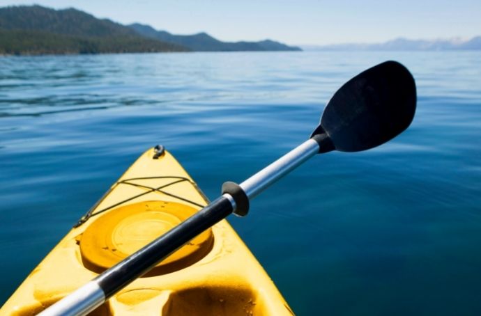 kayaking on lake surrounded by mountains