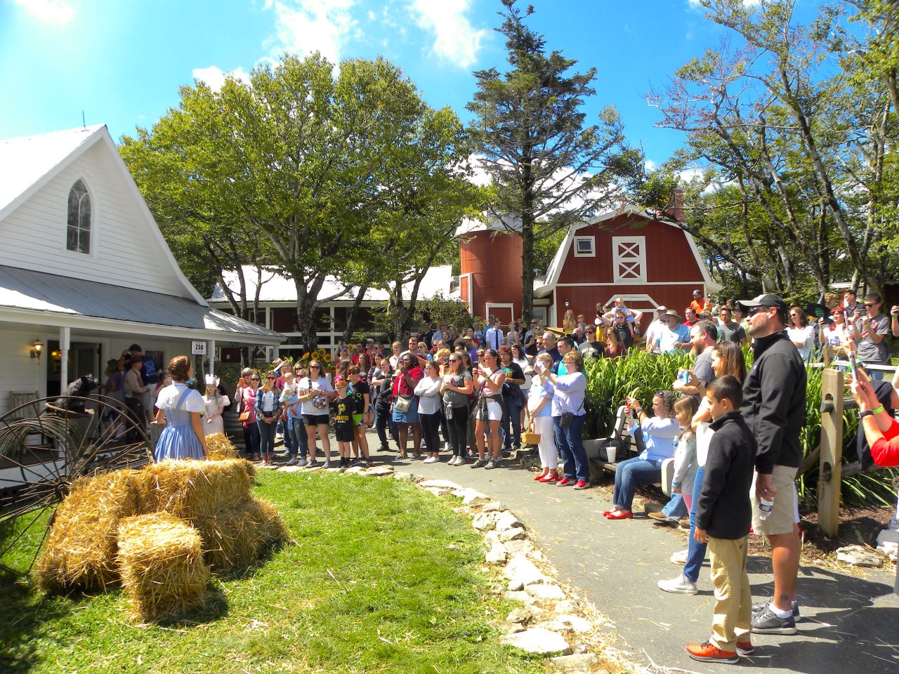 Dorothy entertains a crowd outside her Kansas Home at Autumn at Oz