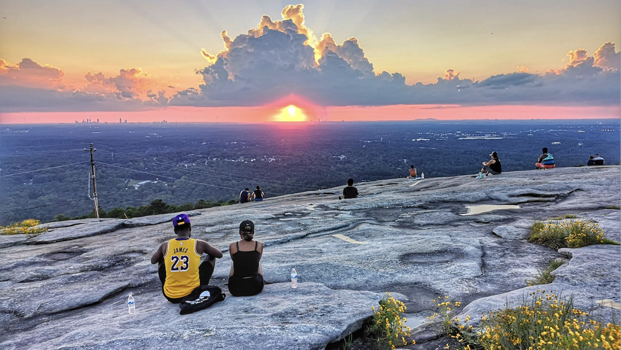 Couple watching Sunset atop Stone Mountain GA