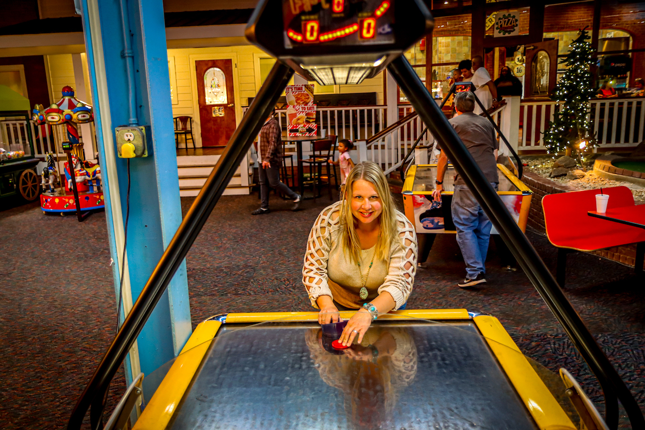 Mary Gabbett playing air hockey at The Factory in Franklin NC